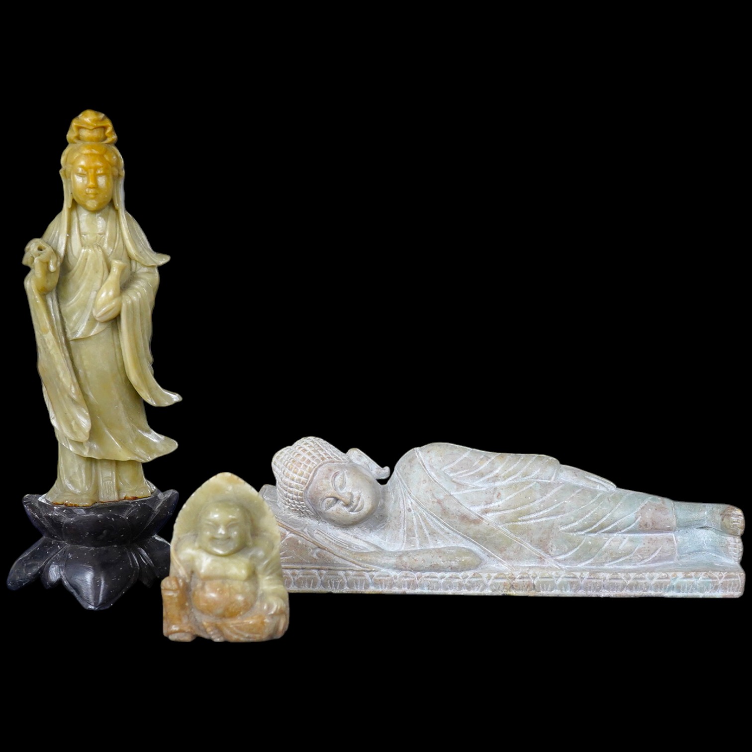 A carved stone reclining buddha, a Chinese deity and a seated buddha, largest 20cm wide. Condition - fair to good